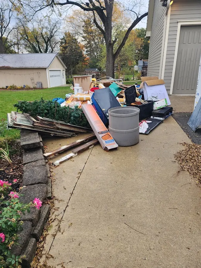 Dumpster being loaded with debris for Estate Cleanout Dumpster Rental in St. Andrews